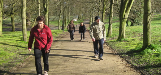Image of 4 people over 50 walking up hill.